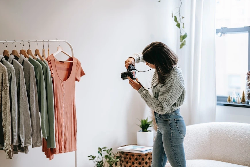 Woman Taking Photos for Poshmark Listing Woman Taking Photos for Poshmark Listing